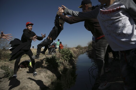 Migrants cross the Rio Grande river into the United States from Ciudad Juarez, Mexico, Wednesday, March 29, 2023. The image was part of a series by Associated Press photographers Ivan Valencia, Eduardo Verdugo, Felix Marquez, Marco Ugarte Fernando Llano, Eric Gay, Gregory Bull and Christian Chavez that won the 2024 Pulitzer Prize for feature photography. (AP Photo/Christian Chavez)