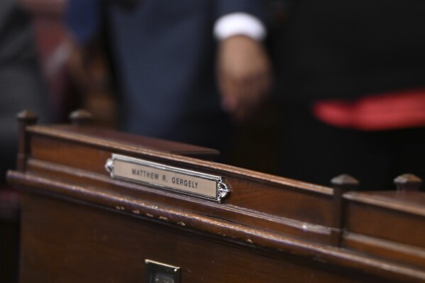 The desk of hospitalized Pennsylvania state Rep. Matt Gergely, D-Allegheny, is empty at the start of the state House's new two-year legislative session, Jan. 7, 2025, in Harrisburg, Pa. Gergely died January 19, leaving his seat vacant and the chamber deadlocked. (AP Photo/Marc Levy, File)