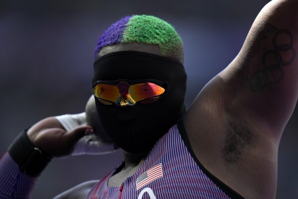 Raven Saunders, of the United States, competes during the women's shot put qualification at the 2024 Summer Olympics, Thursday, Aug. 8, 2024, in Saint-Denis, France. (AP Photo/Ashley Landis)