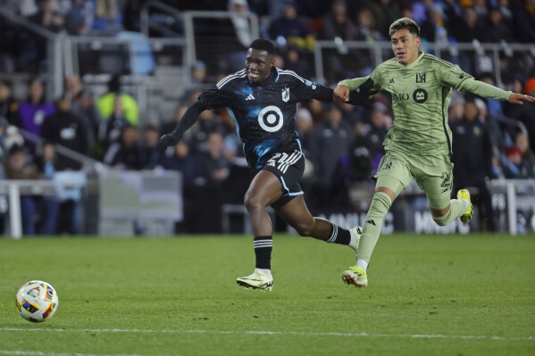 Minnesota United forward Bongokuhle Hlongwane (21) beats Los Angeles FC defender Omar Campos (2) to the ball en route to scoring during the second half of an MLS soccer match Saturday, March 16, 2024, in St. Paul, Minn. (AP Photo/Bruce Kluckhohn)