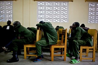 FILE - Soldiers accused of rape and crimes against humanity slouch in their chairs during a military tribunal in the town of Baraka, Democratic Republic of the Congo, Feb. 16, 2011. Congo has lifted a more than two-decade old moratorium on the death penalty to try and rid the country of traitors and acts of "terrorism", said the government. The moratorium, established in 2003, has allowed offenders accused of treachery and espionage, guaranteed impunity, said the justice ministry in a statement that emerged Friday, March 15, 2024. (AP Photo/Pete Muller, File)