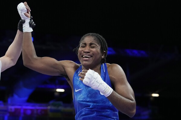 Refugee Olympic Team's Cindy Ngamba celebrates after defeating Canada's Tammara Thibeault in their women's 75 kg preliminary boxing match at the 2024 Summer Olympics, Wednesday, July 31, 2024, in Paris, France. (AP Photo/Ariana Cubillos)