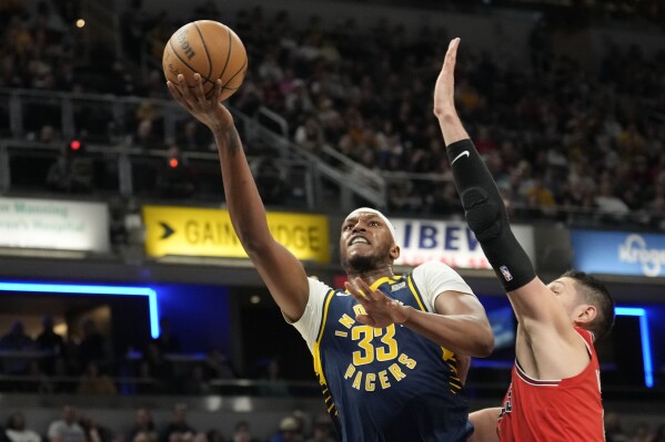 Indiana Pacers center Myles Turner (33) shoots against Chicago Bulls center Nikola Vucevic during the first half of an NBA basketball game in Indianapolis, Wednesday, March 13, 2024. (AP Photo/AJ Mast)