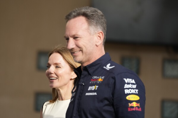 Red Bull team principal Christian Horner, right, walks with his wife Geri Halliwell prior to the Formula One Bahrain Grand Prix at the Bahrain International Circuit in Sakhir, Bahrain, Saturday, March 2, 2024. (AP Photo/Darko Bandic)