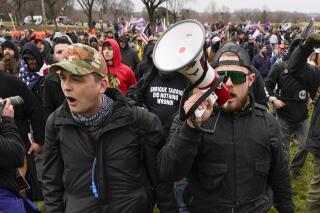 FILE - Proud Boys members Zachary Rehl, left, and Ethan Nordean, walk toward the U.S. Capitol in Washington, in support of President Donald Trump, Jan. 6, 2021. Federal prosecutors disclosed Wednesday, March 22, 2023, that a witness expected to testify for the defense at the seditious conspiracy trial of former Proud Boys leader Enrique Tarrio and four associates was secretly acting as a government informant for nearly two years after the Jan. 6 attack on the U.S. Capitol, a defense lawyer said in a court filing. Carmen Hernandez, a lawyer for Rehl, asked a judge to schedule an immediate emergency hearing and suspend the trial “until these issues have been considered and resolved.” (AP Photo/Carolyn Kaster, File)