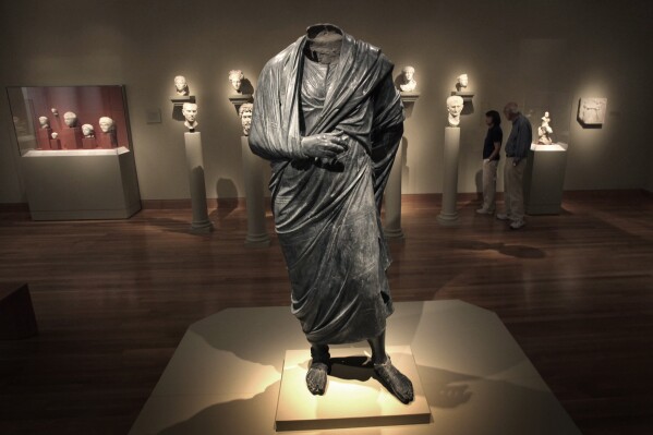 FILE — The Emperor as Philosopher," a Roman-era statue, thought to represent Marcus Aurelius, stands in a gallery at the Cleveland Museum of Art in Cleveland, Ohio, June 25, 2010. A warrant signed by a judge in Manhattan, Aug. 14, 2023, ordered the seizure of the statue, from the Cleveland Museum of Art by New York authorities investigating antiquities looted from Turkey. (AP Photo/Amy Sancetta, File)