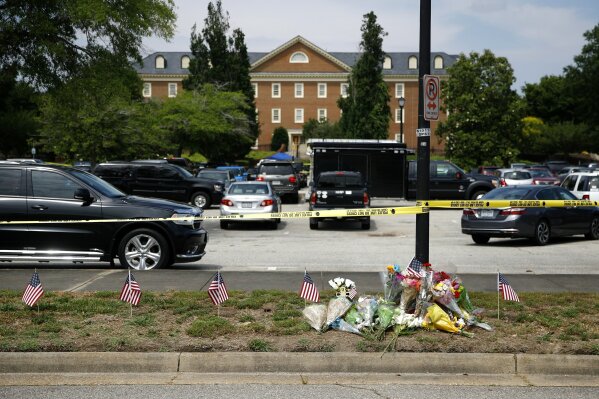 FILE - In this June 1, 2019, file photo, a makeshift memorial rests at the edge of a police cordon in front of a municipal building that was the scene of a shooting in Virginia Beach, Va. As the shooting's one-year anniversary approaches, some of the victim's family members say the rampage is effectively forgotten. (AP Photo/Patrick Semansky, File)