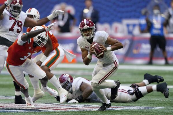 Alabama quarterback Bryce Young (9) scrambles away from Miami safety Gilbert Frierson (3) before throwing a touchdown pass during the first half of an NCAA college football game Saturday, Sept. 4, 2021, in Atlanta. (AP Photo/John Bazemore)
