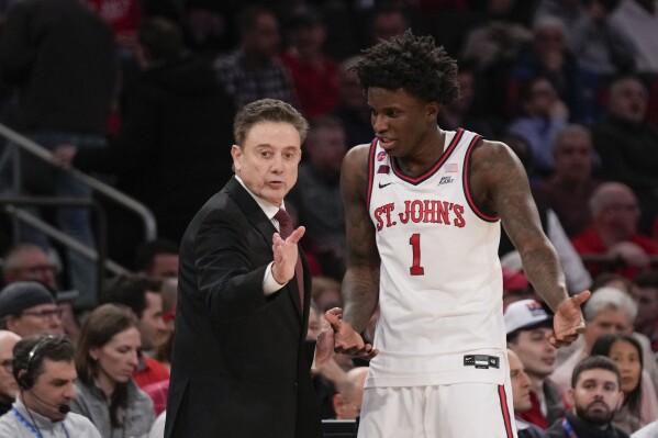 St. John's head coach Rick Pitino, left, talks with Kadary Richmond during the first half of an NCAA college basketball game against Marquette, Tuesday, Feb. 4, 2025, in New York. (AP Photo/Seth Wenig)