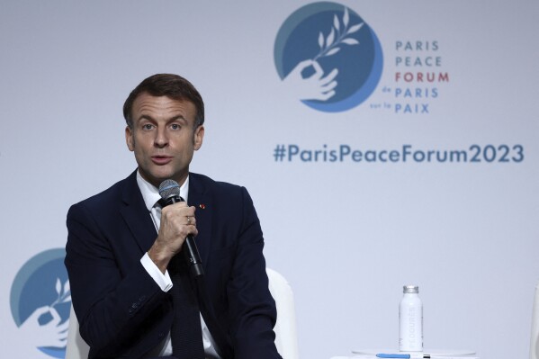 French President Emmanuel Macron delivers a speech at the Paris Peace Forum, in Paris, Friday, Nov. 10, 2023. The Peace Forum is an annual event involving governments, NGOs and others seeking dialogue around global problems such as climate change, children's exposure to online violence, and threats to human rights. (Stephanie Lecocq, Pool via AP)
