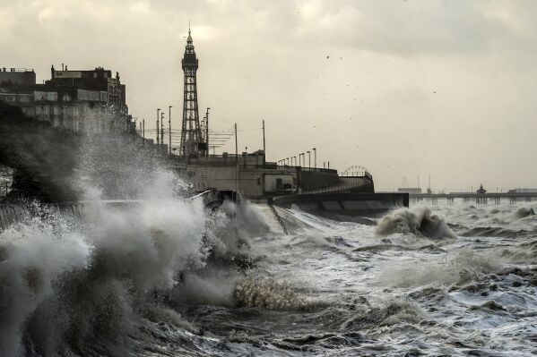 Waves break on the sea front in Blackpool, England, Monday, Jan, 22, 2024. The U.K.'s Met Office weather service had issued an unusual blanket wind warning for the whole country before Storm Isha, which reached its peak overnight. A 99-mile-an-hour gust was recorded at Brizlee Wood radar station in northeastern England. (Danny Lawson/PA via AP)
