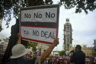People take part to a demonstration against British Prime Minister Boris Johnson, in London, Monday, Sept. 2, 2019. Johnson says he doesn't want an election amid Brexit crisis and issued a rallying cry to lawmakers to back him in securing Brexit deal. (AP Photo/Alberto Pezzali)