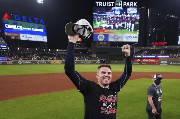 Atlanta Braves Freddie Freeman celebrates after Game 4 of a baseball National League Division Series against the Milwaukee Brewers, Tuesday, Oct. 12, 2021, in Atlanta. The Atlanta Braves won 5-4 to advance to the NLCS. (AP Photo/John Bazemore)