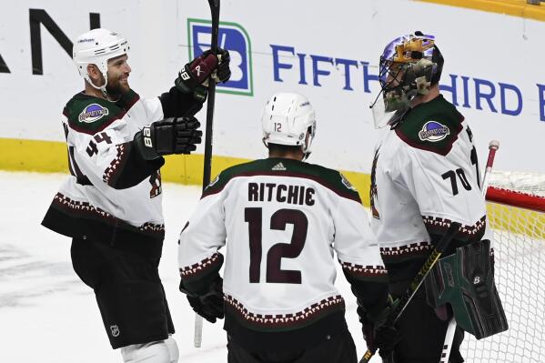 Arizona Coyotes goaltender Karel Vejmelka (70) is congratulated by right wing Zack Kassian (44) and left wing Nick Ritchie (12) after their win over the Nashville Predators in an NHL hockey game Monday, Feb. 13, 2023, in Nashville, Tenn. (AP Photo/Mark Zaleski)