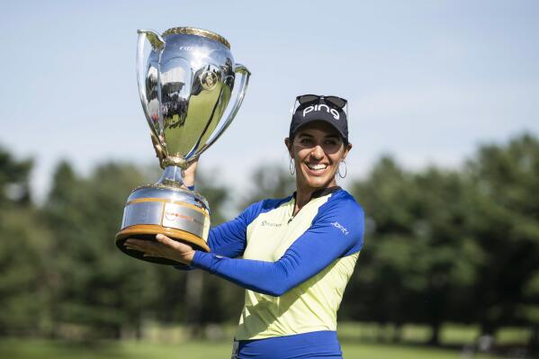 Paula Reto, of South Africa, holds the trophy after winning the the Canadian Pacific Women's Open golf tournament in Ottawa, on Sunday, Aug. 28, 2022. (Justin Tang/The Canadian Press via AP)