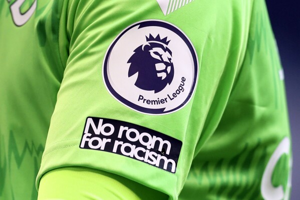 FILE - A Premier League logo is visible on the shirt of Everton's goalkeeper Jordan Pickford during the English Premier League soccer match between Tottenham Hotspur and Everton at the Tottenham Hotspur Stadium in London on Sunday, Sept. 13, 2020. The Premier League says clubs will trial two new forms of spending caps from next season. Teams in England’s top division will trial a “Squad Cost Rules” (SCR) system. SCR will limit spending on players to 85% of a club’s soccer revenue and net profit or loss on player sales. (Cath Ivill/Pool via AP, File)