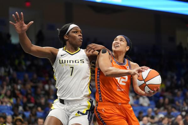 Connecticut Sun center Brionna Jones (42) looks to shoot against Dallas Wings center Teaira McCowan (7) during the first half of a WNBA basketball game in Arlington, Texas, Tuesday, July 5, 2022. (AP Photo/LM Otero)