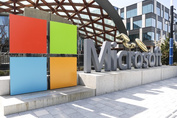 A Microsoft sign and logo are pictured at the company's headquarters, Friday, April 4, 2025, in Redmond, Wash. (AP Photo/Jason Redmond, File)