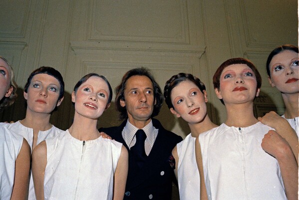 French fashion designer Marc Bohan is pictured with his models after the Dior collection presentation in Paris, Jan. 29, 1970. French designer Marc Bohan who served as Dior's artistic director for nearly three decades died at age 97 Wednesday, Sept. 6, 2023. (AP Photo/Jean-Jacques Levy)