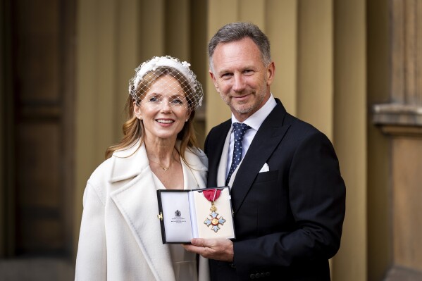 Team Principal and Chief Executive Officer of Red Bull Racing Christian Horner, right, poses with his wife wife Geri Horner after being made a Commander of the Order of the British Empire at an Investiture ceremony at Buckingham Palace in London, Wednesday Dec. 18, 2024. (Aaron Chown/PA via AP, Pool)