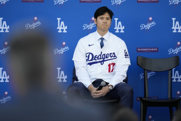 Los Angeles Dodgers' Shohei Ohtani listens to questions during a baseball news conference at Dodger Stadium Thursday, Dec. 14, 2023, in Los Angeles. (AP Photo/Ashley Landis)