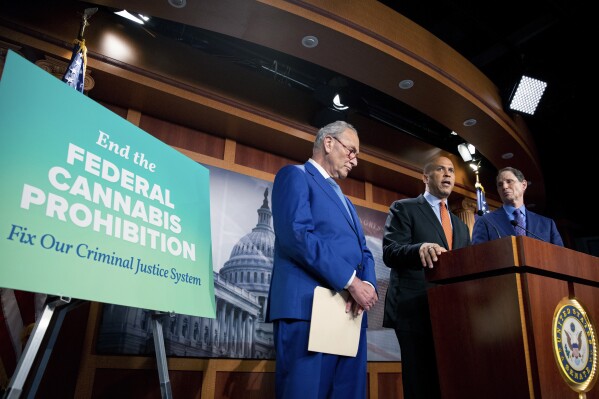FILE - From left, Senate Majority Leader Chuck Schumer, D-N.Y., Sen. Cory Booker, D-N.J., and Sen. Ron Wyden, D-Ore., announce a draft bill that would decriminalize marijuana on a federal level Capitol Hill in Washington, Wednesday, July 14, 2021. (AP Photo/Amanda Andrade-Rhoades, File)