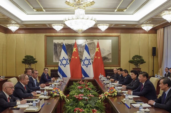 FILE - Israeli Prime Minister Benjamin Netanyahu, third left, and Chinese President Xi Jinping, third right, attend their meeting at Diaoyutai State Guesthouse on March 21, 2017 in Beijing, China. In June 2023, Chinese President Xi Jinping hosted the Palestinian president in Beijing and invited the Israeli prime minister for an official state visit. Benjamin Netanyahu accepted, and China was on track for a bigger role in the region. Then came the attack, which has made Netanyahu’s trip uncertain and all the more so because of China's stated neutrality on the war. (Etienne Oliveau/Pool Photo via AP, File)