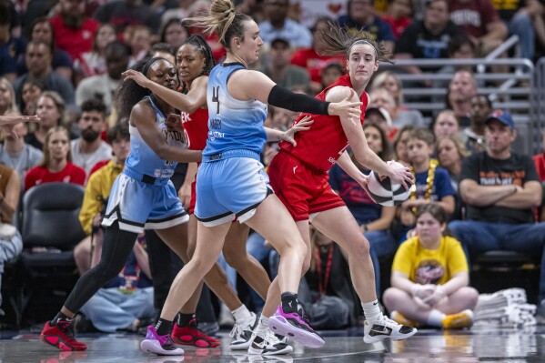 Indiana Fever guard Caitlin Clark, right, looks to pass as Chicago Sky guard Marina Mabrey (4) defends during the second half of a WNBA basketball game Saturday, June 1, 2024, in Indianapolis. (AP Photo/Doug McSchooler)