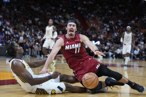 Miami Heat forward Jaime Jaquez Jr. (11) is fouled by Indiana Pacers forward Aaron Nesmith (23) as he drives to the basket during the first half of an NBA basketball game, Thursday, Nov. 30, 2023, in Miami. (AP Photo/Wilfredo Lee)