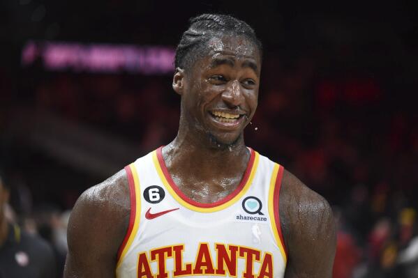 Atlanta Hawks forward A.J. Griffin smiles after getting drenched by his teammates during a celebration after he made the winning shot at the buzzer in overtime against the Toronto Raptors in an NBA basketball game, Saturday, Nov. 19, 2022, in Atlanta. (AP Photo/Hakim Wright Sr.)