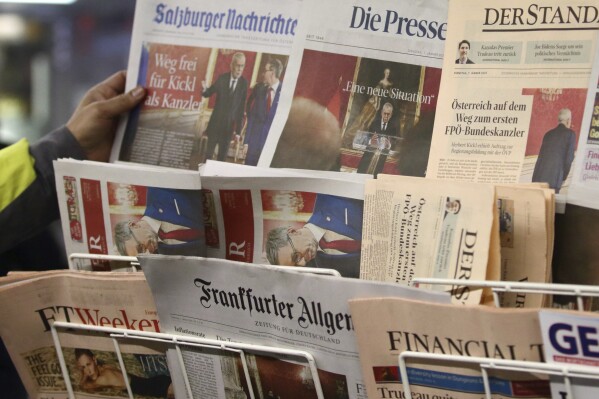 Newspapers are seen on a sales stand in Vienna, Austria, Tuesday, Jan 7, 2025. (AP Photo/Heinz-Peter Bader)