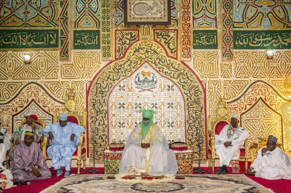 Atiku Abubakar, Presidential candidate of the People's Democratic party, left, visits the Emir of Kano Aminu Ado Bayero, centre, at his palace before an election campaign in Kano, Nigeria Thursday, Feb. 9, 2023. (AP Photo/Sani Maikatanga)