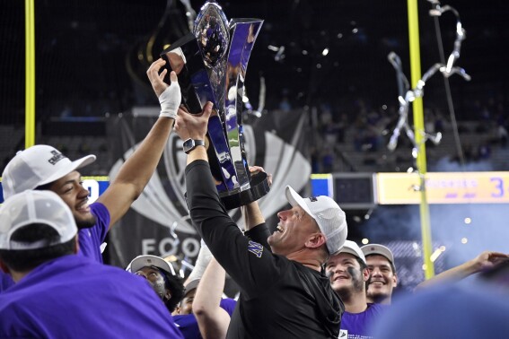 Washington coach Kalen DeBoer celebrates with the trophy after the team's win over Oregon in the Pac-12 championship NCAA college football game Friday, Dec. 1, 2023, in Las Vegas. (AP Photo/David Becker)