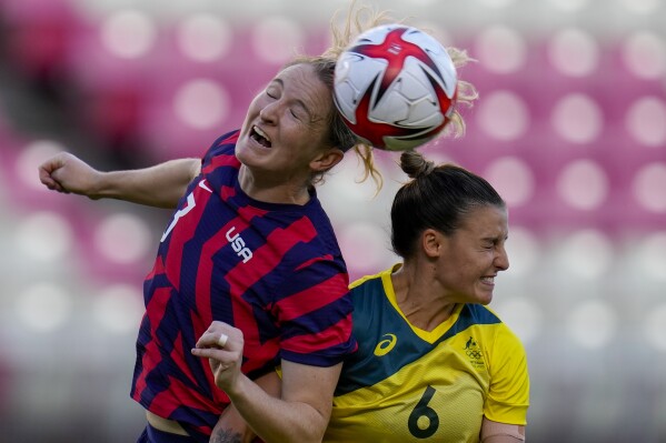 FILE - United States' Samantha Mewis and Australia's Chloe Logarzo go for a header in the women's bronze medal soccer match at the 2020 Summer Olympics, Thursday, Aug. 5, 2021, in Kashima, Japon. Samantha Mewis, who played for the U.S. team that won the 2019 Women's World Cup, has retired from soccer because of a knee injury that has sidelined her from the national team since the Tokyo Olympics. (AP Photo/Fernando Vergara, File)