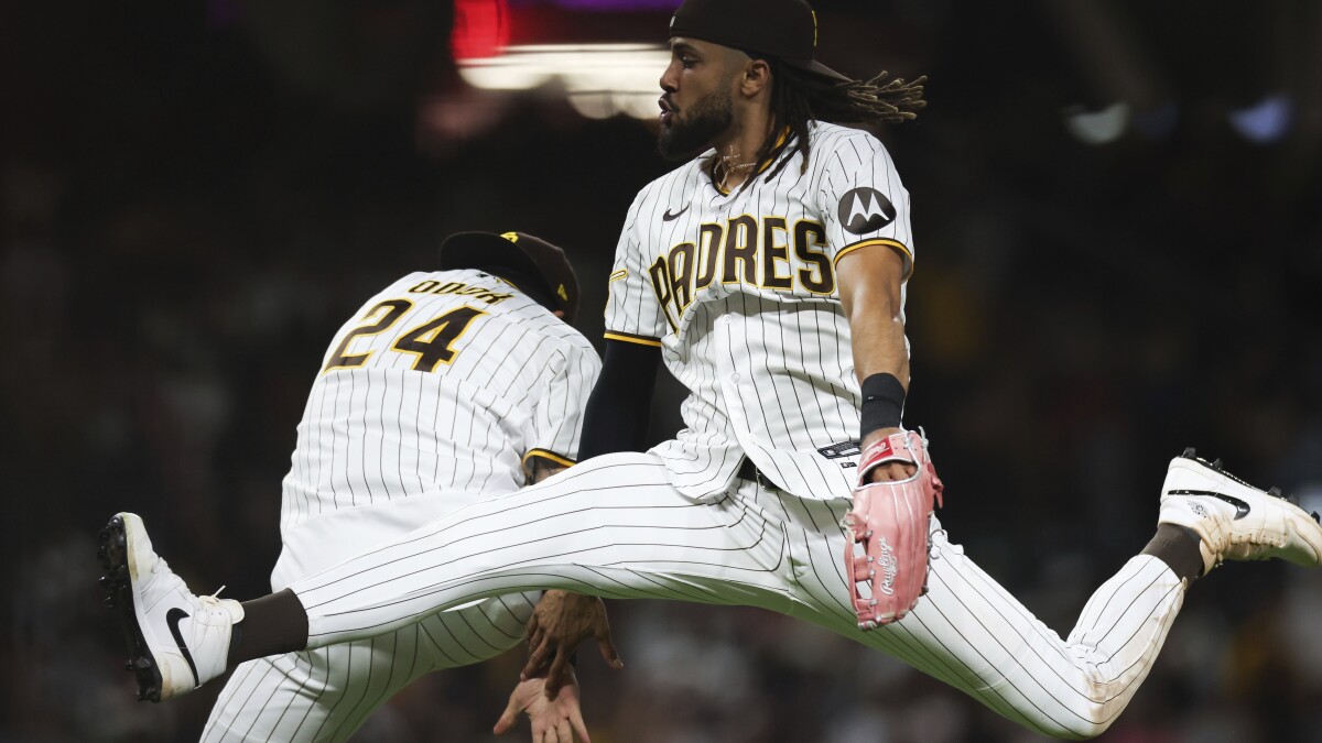 The San Diego Padres' Manny Machado is congratulated by teammate Rougned  Odor after he hit a