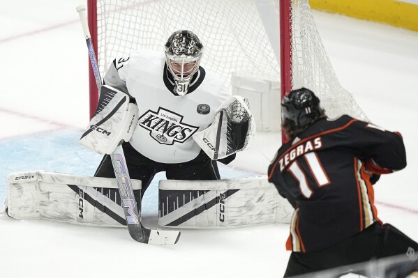 Los Angeles Kings goaltender David Rittich, left, deflects a shot by Anaheim Ducks center Trevor Zegras during the first period of an NHL hockey game Saturday, April 13, 2024, in Los Angeles. (AP Photo/Mark J. Terrill)