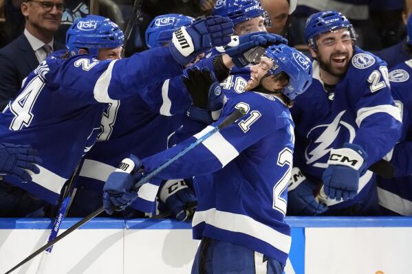 Tampa Bay Lightning center Brayden Point (21) celebrates with the bench after scoring against the Detroit Red Wings during the third period of an NHL hockey game Thursday, April 13, 2023, in Tampa, Fla. (AP Photo/Chris O'Meara)