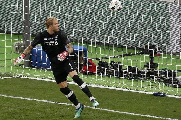 FILE - Liverpool goalkeeper Loris Karius looks at the ball after a fumble allowed Real Madrid's Gareth Bale to score his side's 3rd goal during the Champions League Final soccer match between Real Madrid and Liverpool at the Olimpiyskiy Stadium in Kiev, Ukraine, May 26, 2018. Loris Karius could be back in the spotlight. The Newcastle goalkeeper is in line to play Sunday against Manchester United in the English League Cup final at Wembley. It's been nearly five years since his last appearance for an English club. The German’s gaffes — later shown to be concussion related — were costly in Liverpool’s 3-1 loss to Real Madrid in the 2018 Champions League final. (AP Photo/Darko Vojinovic, File)