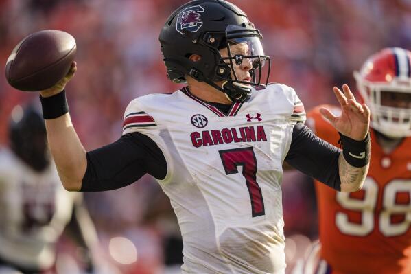 South Carolina quarterback Spencer Rattler (7) drops back to pass in the second half of an NCAA college football game against Clemson on Saturday, Nov. 26, 2022, in Clemson, S.C. (AP Photo/Jacob Kupferman)