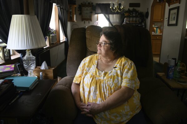 Doris Kelley, 57, sits in her home on Monday, June 29, 2020 in Ruffs Dale, Pa. Kelley was one of the first patients in a UPMC trial for COVID-19. “It felt like someone was sitting on my chest and I couldn’t get any air,” Kelley said of the disease. (AP Photo/Justin Merriman)
