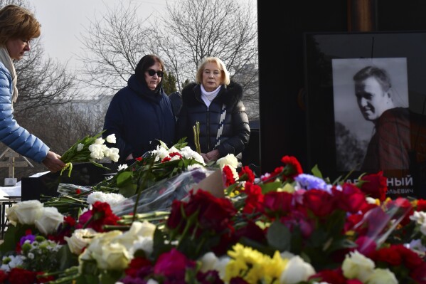 FILE - Russian opposition leader Alexei Navalny's mother, Lyudmila Navalnaya, center left, and his mother-in-law Alla Abrosimova visit his grave at the Borisovskoye Cemetery, in Moscow, Russia, on Saturday, March 2, 2024. A Russian court has rejected a lawsuit filed by the mother of Alexei Navalny, the Russian opposition stalwart who died in prison in February, that claimed he received inadequate medical care, a close Navalny colleague said Thursday, March 21, 2024. (AP Photo, File)