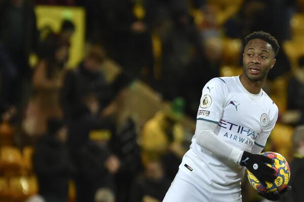Manchester City's Raheem Sterling holds the ball at the end of the English Premier League soccer match between Norwich City and Manchester City at Carrow Road Stadium in Norwich, England, Saturday, Feb. 12, 2022. (AP Photo/Rui Vieira)