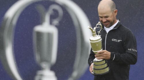 United States' Brian Harman poses for the media as he holds the Claret Jug trophy for winning the British Open Golf Championships at the Royal Liverpool Golf Club in Hoylake, England, Sunday, July 23, 2023. (AP Photo/Peter Morrison)