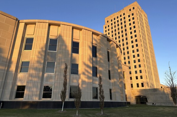 Sunlight illuminates the exterior of the North Dakota House of Representatives and the state Capitol tower in Bismarck, N.D., on Nov. 10, 2023. (AP Photo/Jack Dura, File)
