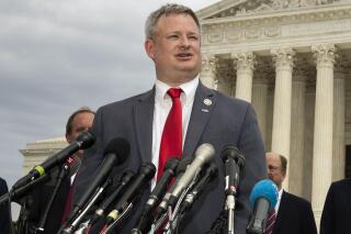 FILE - South Dakota Attorney General Jason Ravnsborg, joined by a bipartisan group of state attorneys general, speaks to reporters in front of the U.S. Supreme Court in Washington on Sept. 9, 2019. On Monday, Jan. 24, 2022, South Dakota Gov. Kristi Noem pressured House lawmakers weighing impeachment charges against Ravnsborg to release investigative files on his 2020 fatal car crash. (AP Photo/Manuel Balce Ceneta, File)