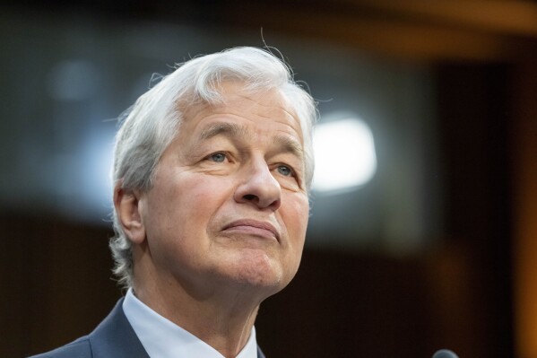 FILE - Jamie Dimon, Chairman and CEO, JPMorgan Chase & Co., listens during a Senate Banking, Housing, and Urban Affairs Committee oversight hearing to examine Wall Street firms on Capitol Hill, Wednesday, Dec. 6, 2023 in Washington. Dimon says stagflation could be one of a number of possible outcomes for the economy as the Federal Reserve attempts to tame stubbornly high consumer prices, Friday, April 26, 2024.(AP Photo/Alex Brandon, File)