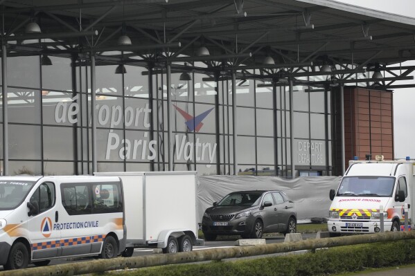 Rescue vehicles park outside the Vatry airport, eastern France, Saturday, Dec. 23, 2023 in Vatry, eastern France. About 300 Indian citizens heading to Central America were sequestered in a French airport for a third day Saturday because of an investigation into suspected human trafficking, authorities said. The 15 crew members of the Legend Airlines charter flight en route from United Arab Emirates to Nicaragua were questioned and released, according to a lawyer for the small Romania-based airline. (AP Photo/Christophe Ena)