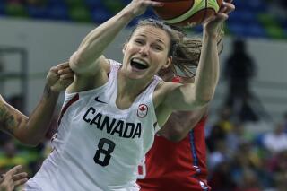 FILE - Canada guard Kim Gaucher pulls down a rebound during the first half of a women's basketball game against the United States at the 2016 Summer Olympics in Rio de Janeiro, Brazil, in this Friday, Aug. 12, 2016, file photo. Canadian basketball player Kim Gaucher, who is breastfeeding her infant daughter, has won in her quest to bring the baby to the Tokyo Olympics.
The International Olympic Committee says nursing mothers will now be allowed to bring their babies to Tokyo. (AP Photo/Carlos Osorio, File)