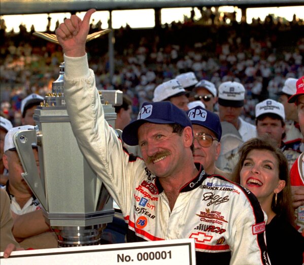 FILE -  In this Aug. 5, 1995 file photo, NASCAR driver Dale Earnhardt of Mooresville, N.C., gives a "thumbs up" to the crowd from victory lante after winning the Brickyard 400 auto race at the Indianapolis Motor Speedway in Indianapolis. (AP Photo/Tom Strattman, File)