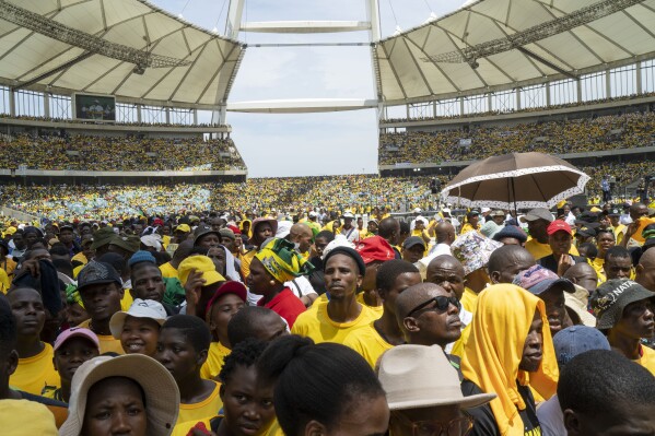 African National Congress supporters listen to South African President Cyril Ramaphosa at the Mose Mabhida stadium in Durban, South Africa, Saturday, Feb. 24, 2024, during their national manifesto launch in anticipation of the 2024 general elections. (AP Photo/Jerome Delay)